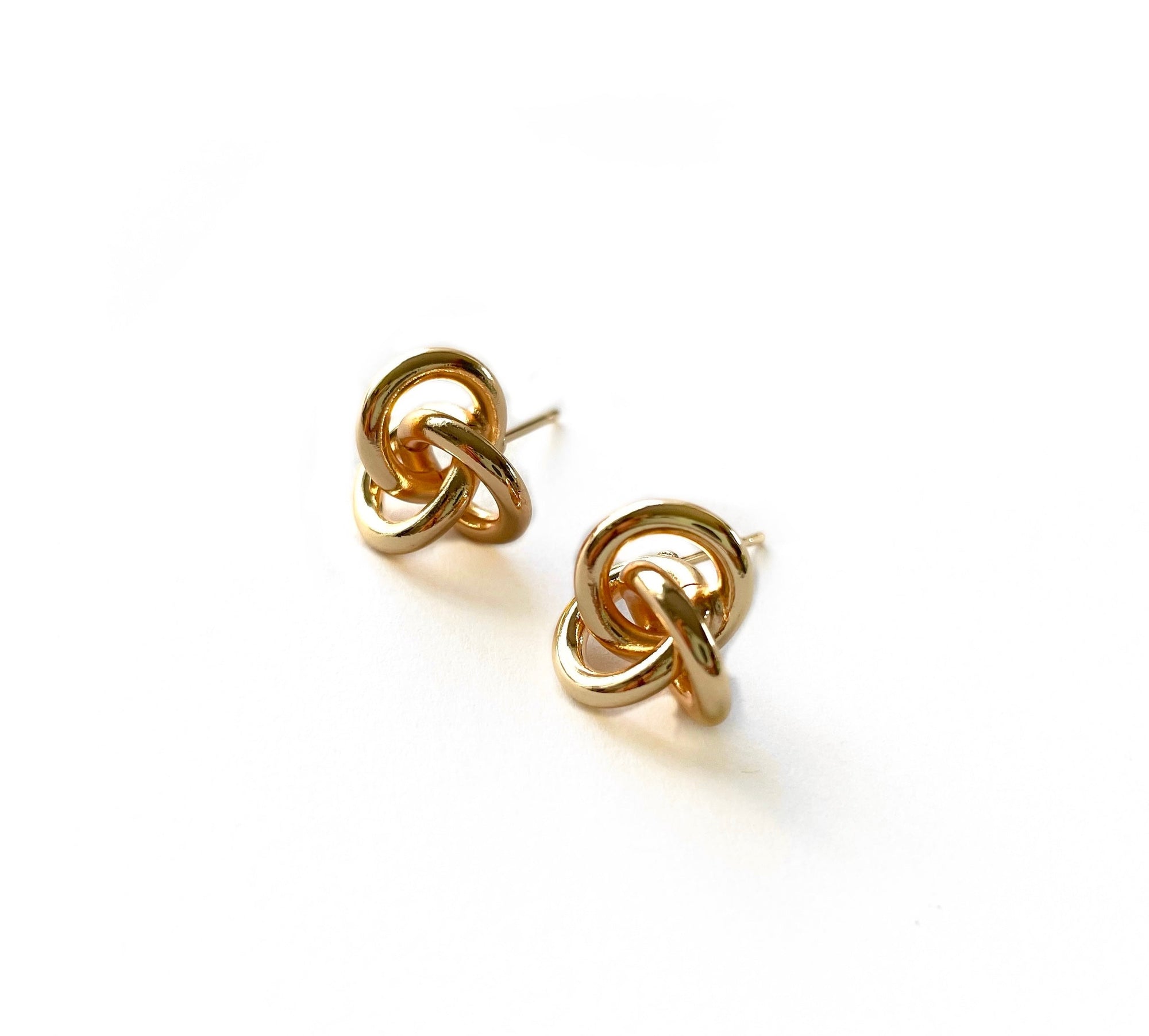 small knot stud earring in a shiny gold finish