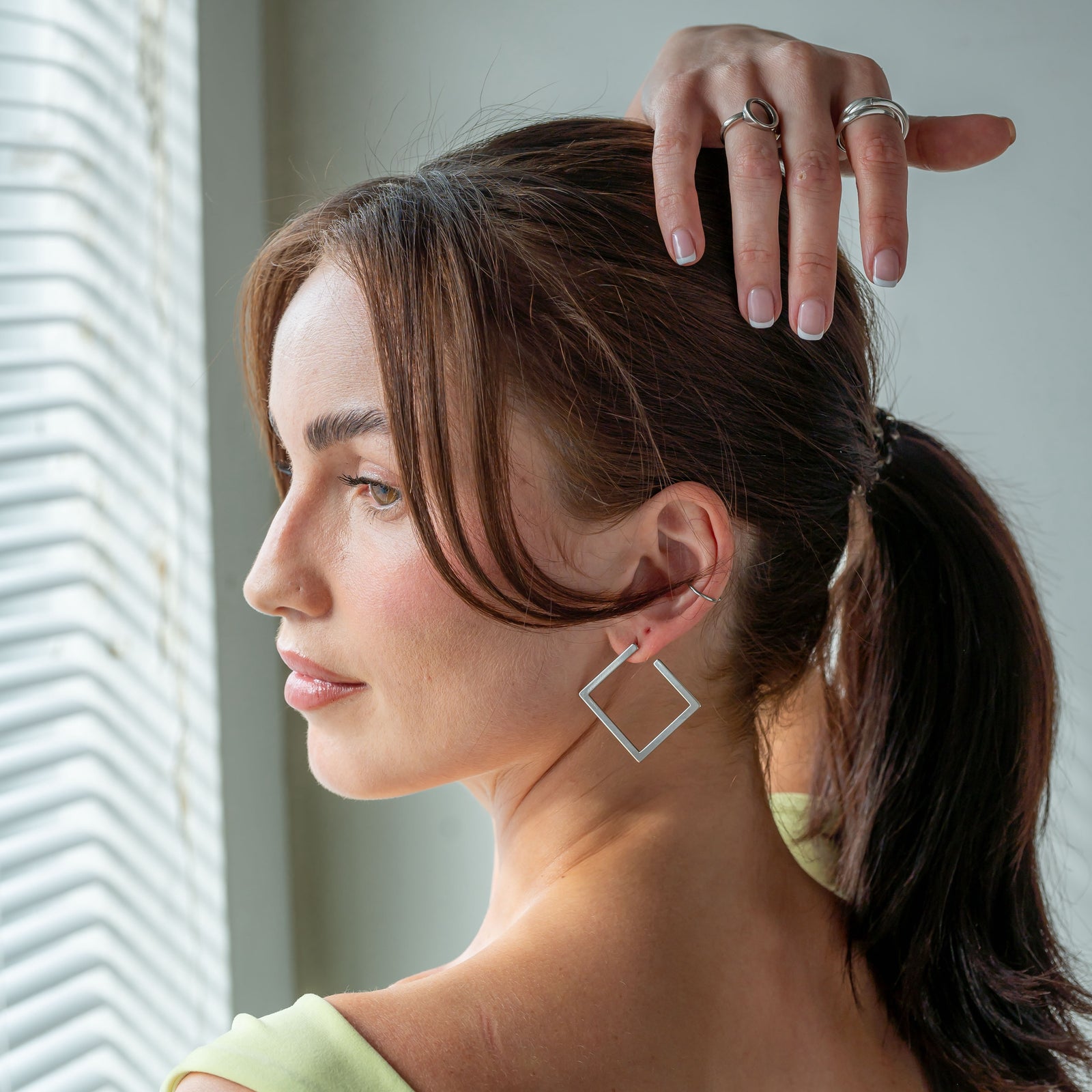 medium sized silver plated stud earrings in a square shape with a shiny finish