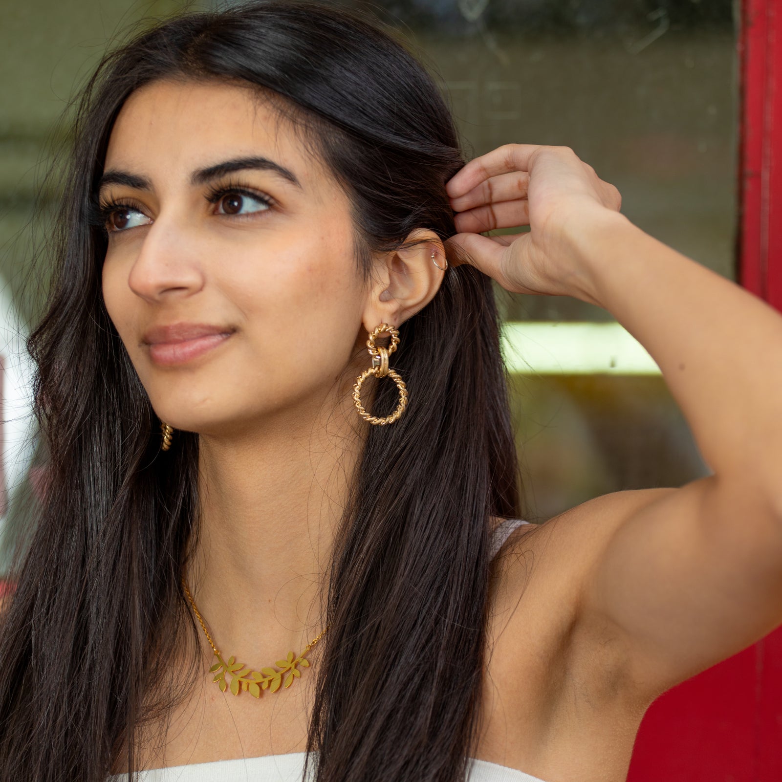 opulent gold linked hoop earrings with a twisted rope design 