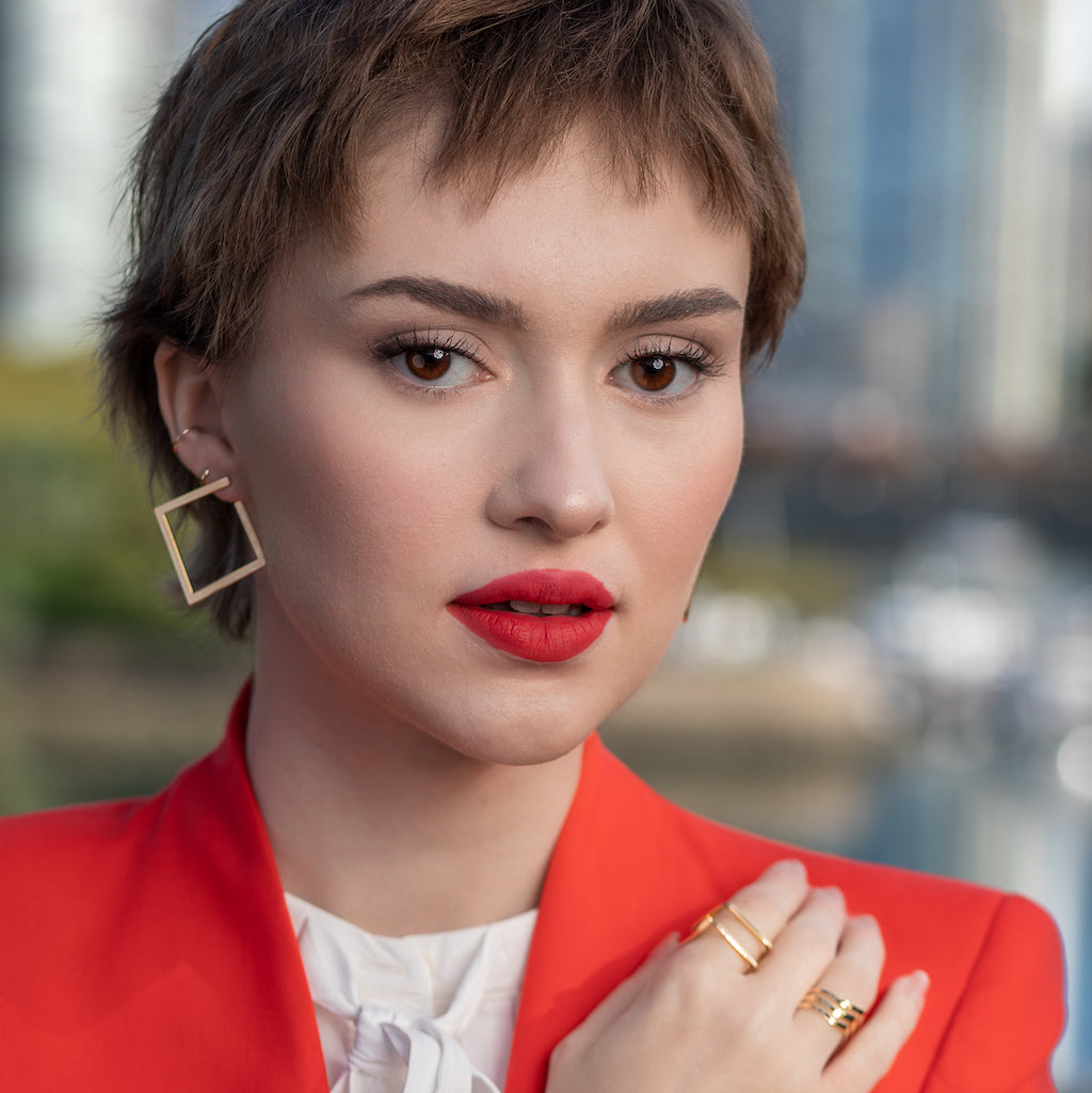 medium sized gold plated stud earrings in a square shape with a shiny finish