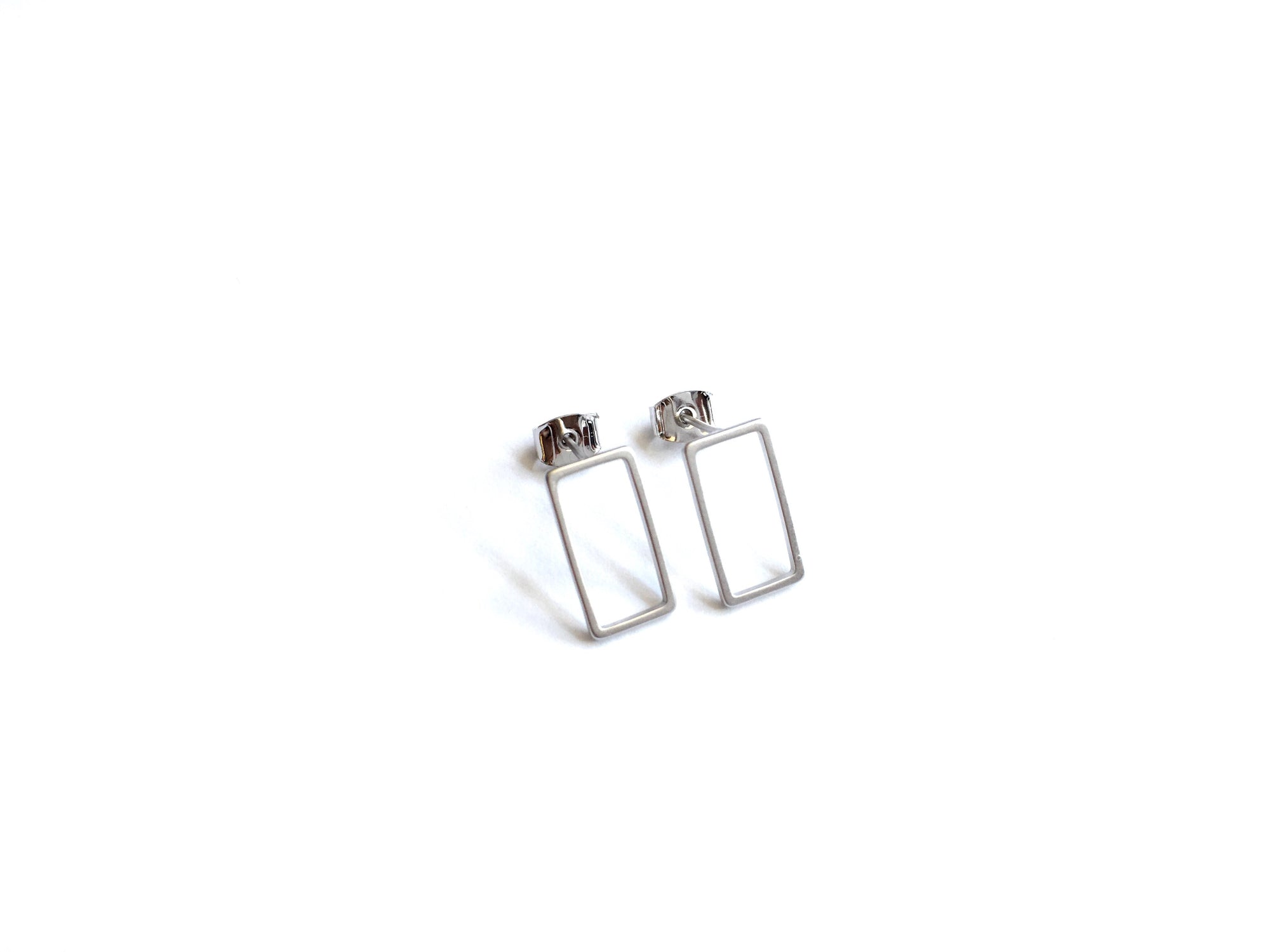 silver elegant statement piece with dainty open rectangle shaped stud earrings in a gold finish 