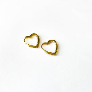 small and dainty open heart shaped huggie earrings in a gold finish over italian brass